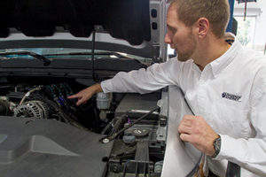 Operations Director Matt Hyde explains some of the modifications made to this vehicle so it could operate on an alternative fuel. Brian Schoenhals/The Daily Home 